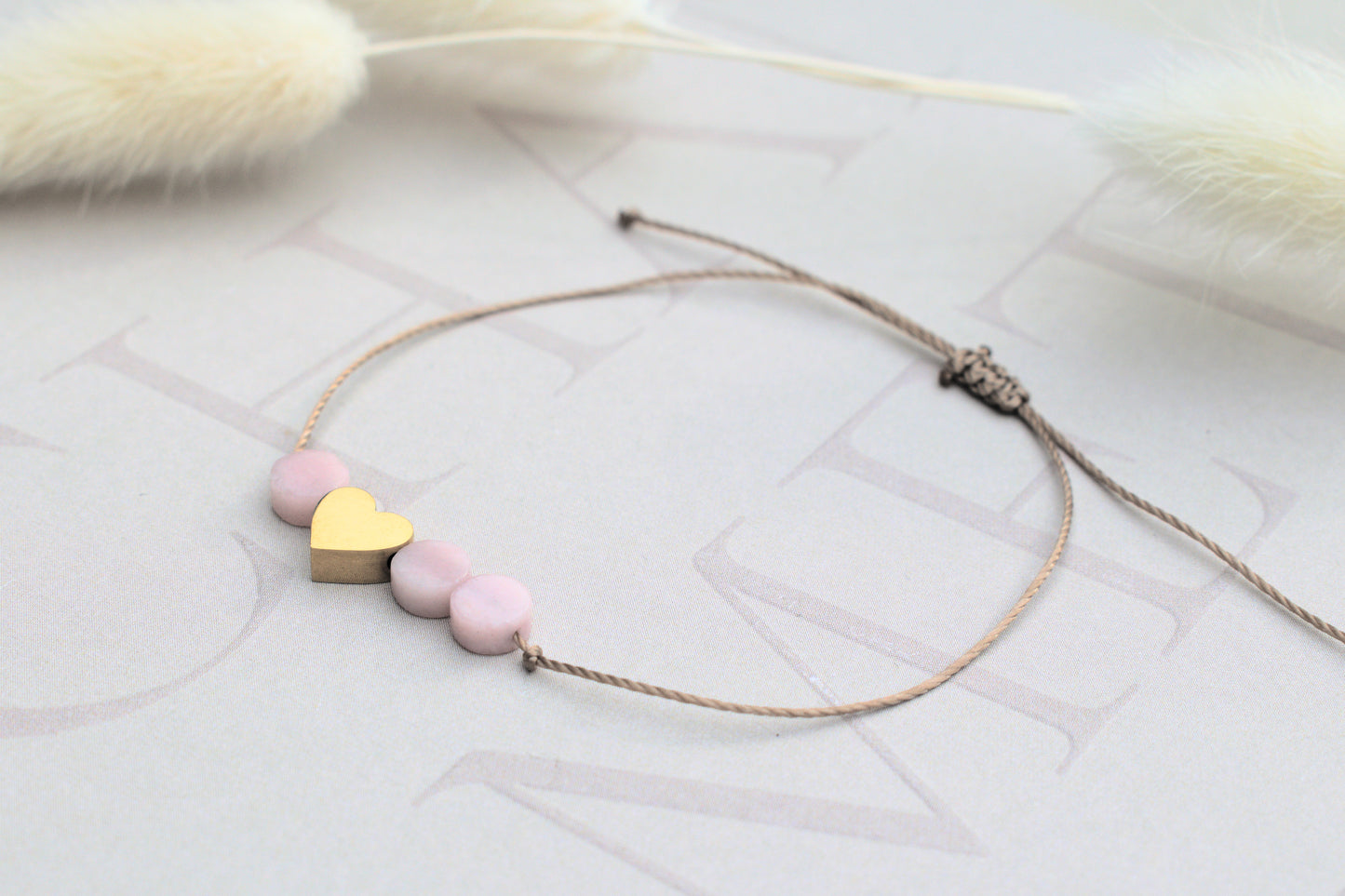 Freundschaftsarmband mit einem goldenen flachen Herz und drei kleinen rosa Opal Edelsteinen flach geschliffen